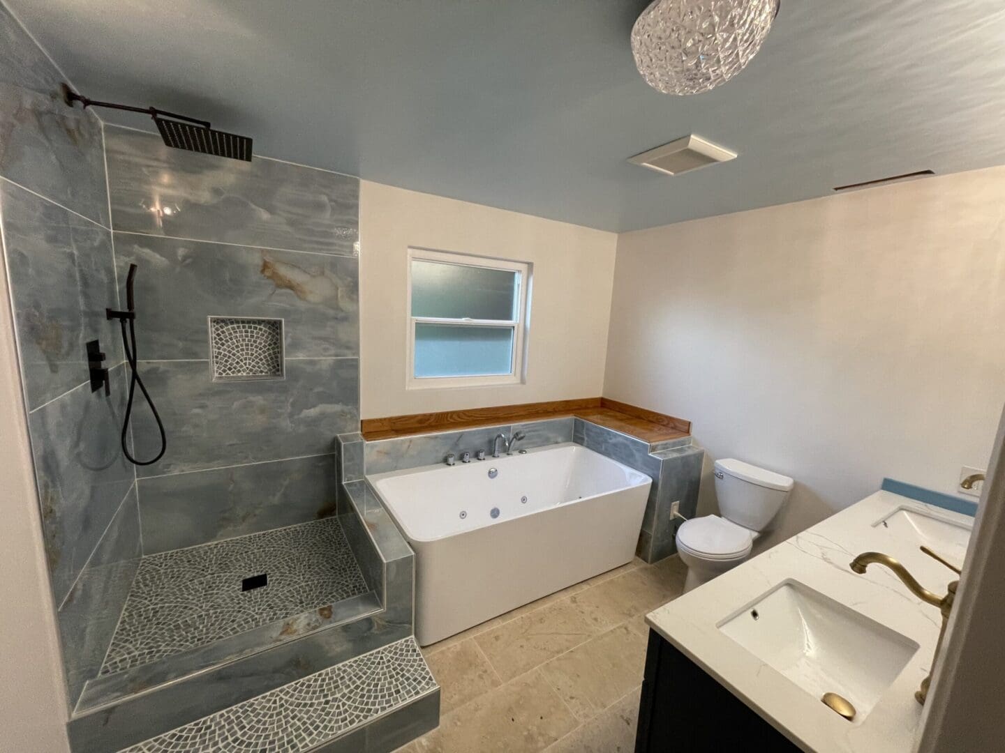 a bathroom with a shower area and a bath tub