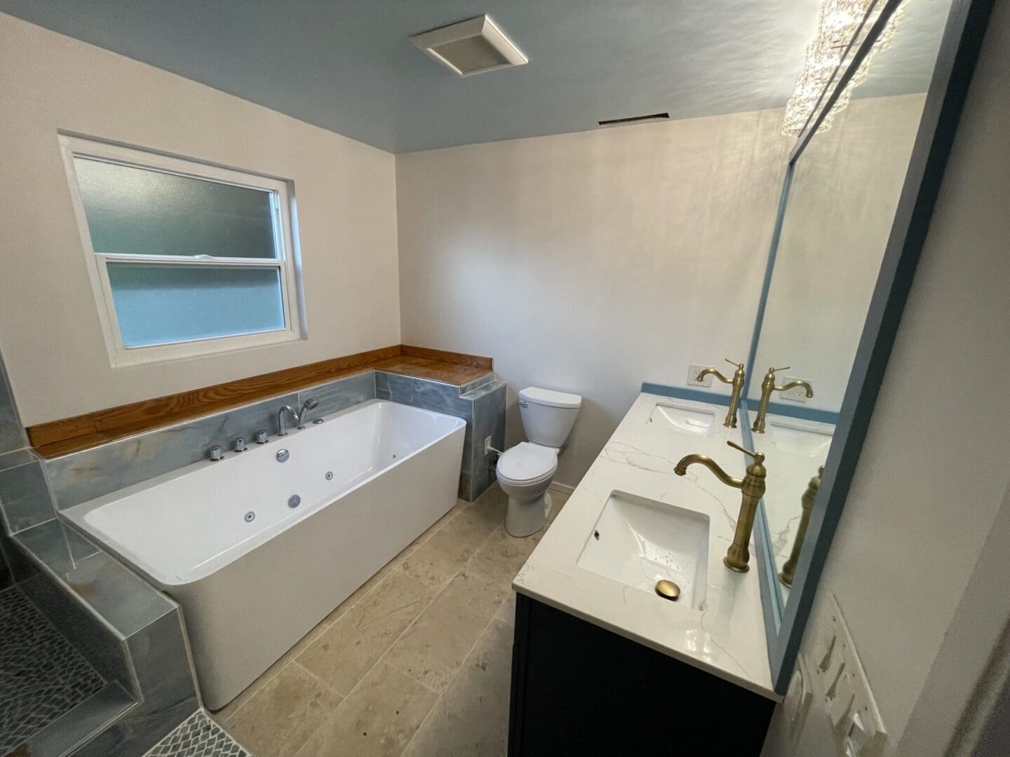 a bathroom with a commode, bath tub, and sink
